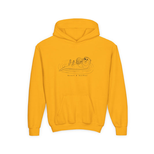 Yellow hoodie with a hand-drawn sea otter by heart and harbor.