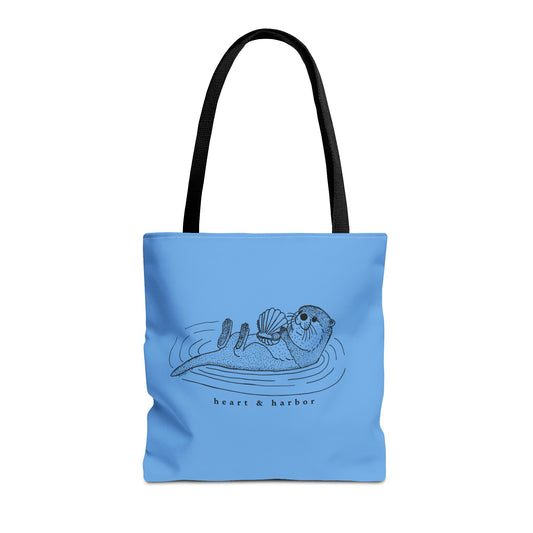 Blue tote bag with hand-drawn sea otter by heart & harbor