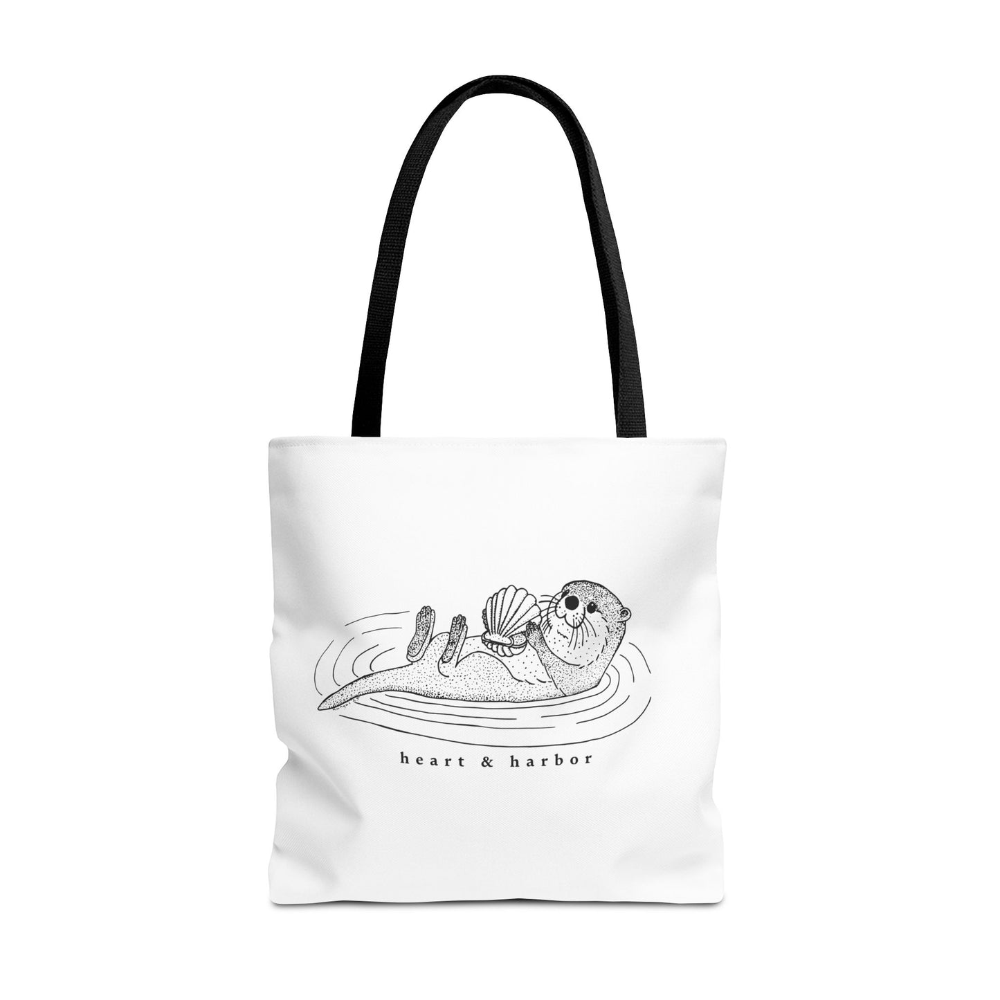 White tote bag with hand-drawn sea otter by heart & harbor.