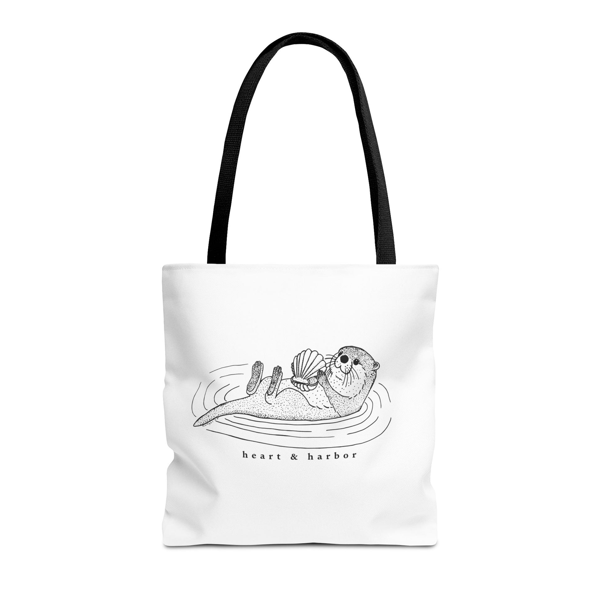 White tote bag with hand-drawn sea otter by heart & harbor.