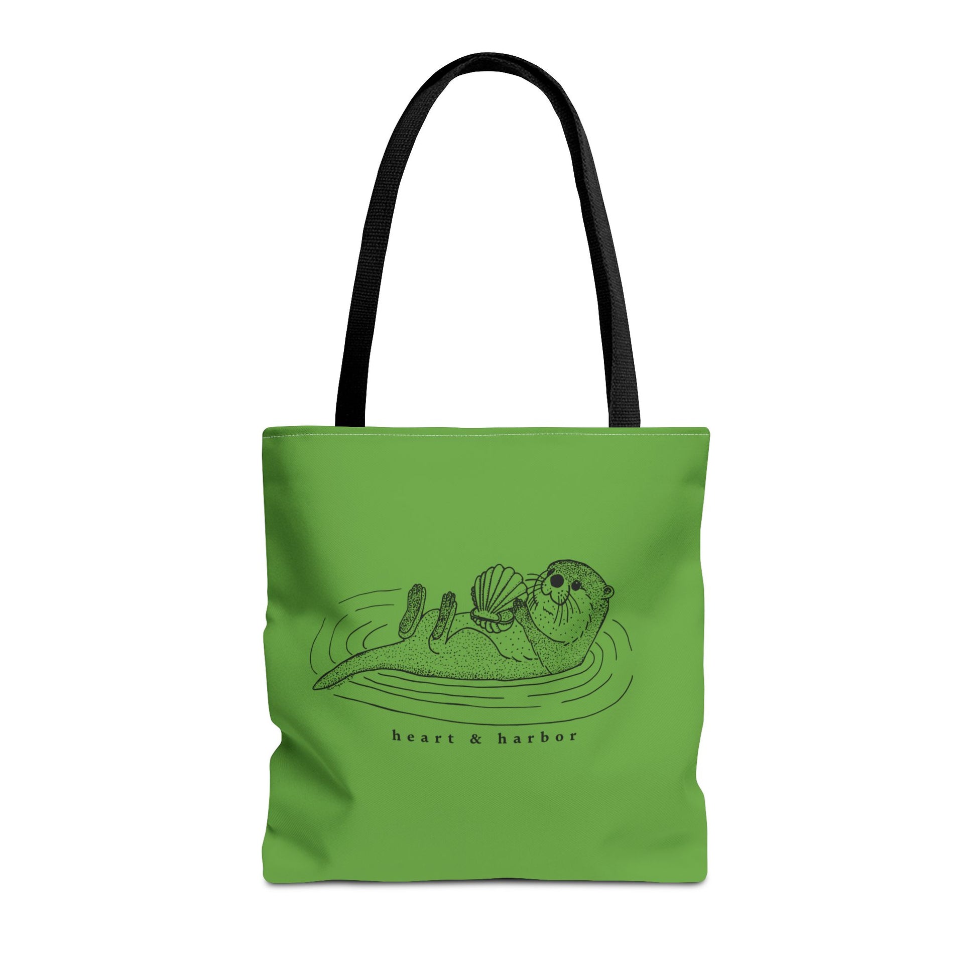 Green tote bag with hand-drawn sea otter by heart & harbor.