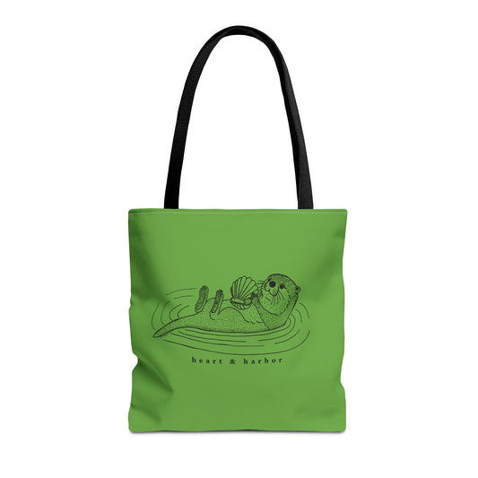 Green tote bag with hand-drawn sea otter by heart & harbor.