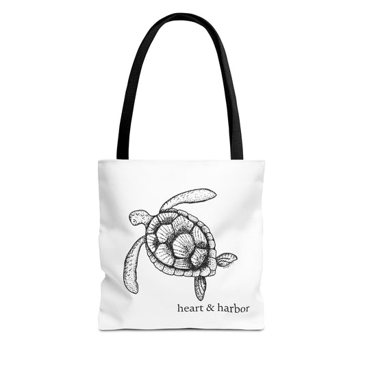 White tote bag with a hand-drawn sea turtle design by heart & harbor.