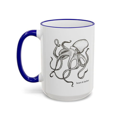 15 oz white ceramic mug with blue handle featuring Heart & Harbor octopus artwork