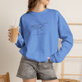 Person wearing a blue hand-drawn whale crewneck sweatshirt by Heart & Harbor