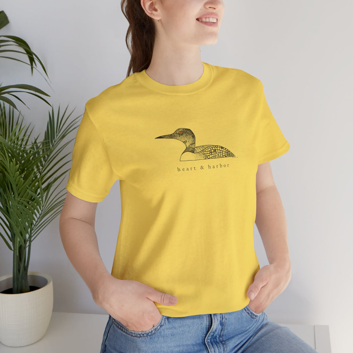 Unisex yellow Bella+Canvas 3001 tee featuring original hand-drawn Heart & Harbor common loon artwork