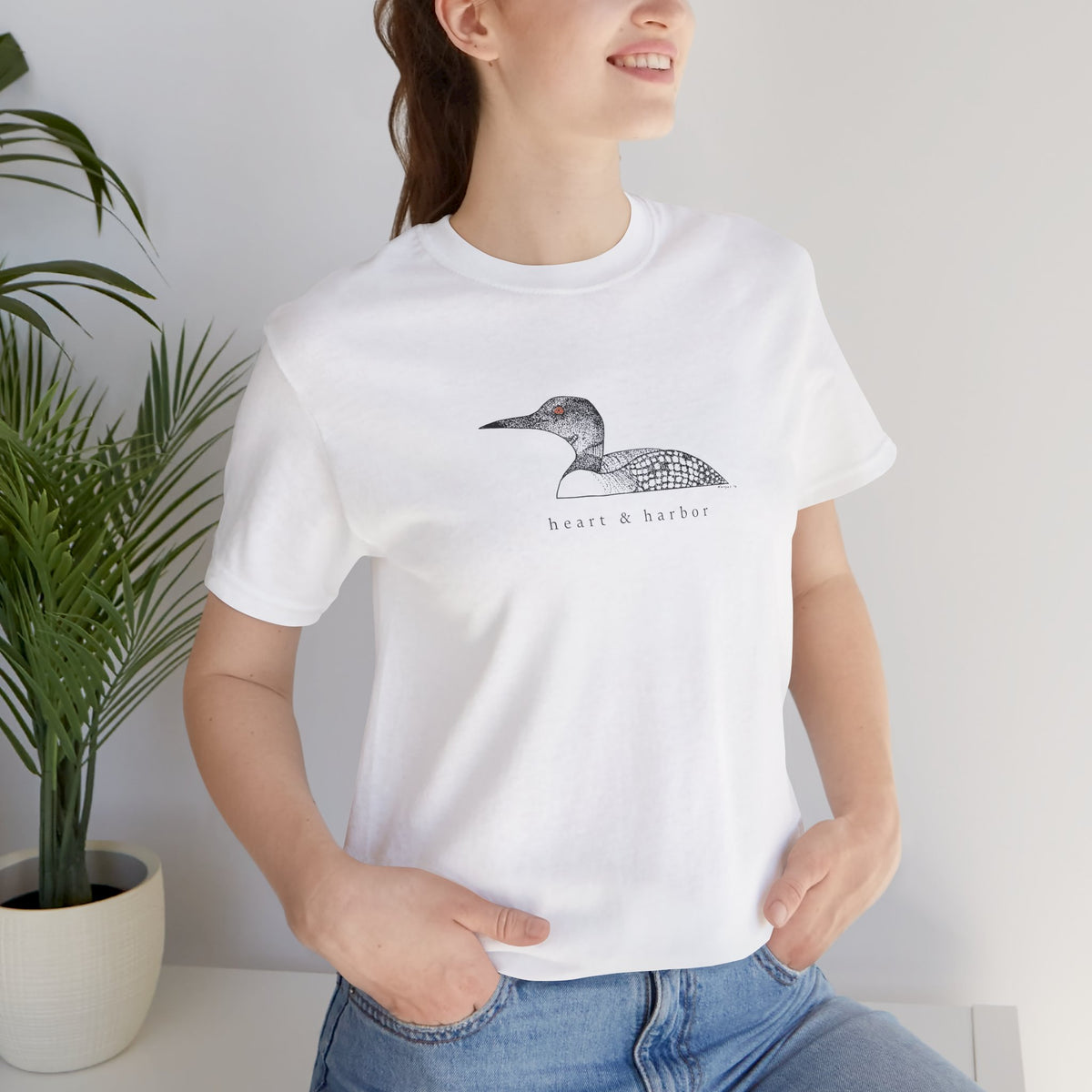 Unisex White Bella+Canvas 3001 tee featuring original hand-drawn Heart & Harbor common loon artwork